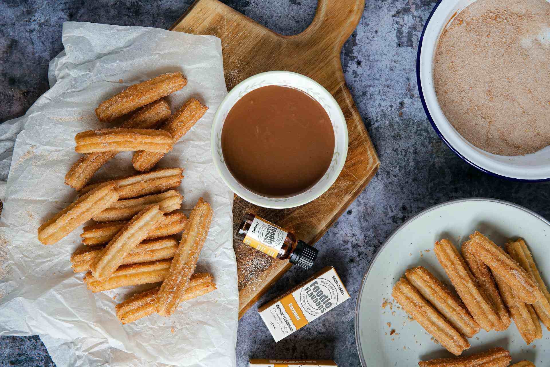 A platter of churros and hot chocolates served with caramel